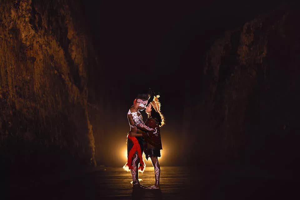 Photo of an Indonesian couple wearing traditional Papuan clothing -- photo by the Hey Bali team at Pandawa Beach