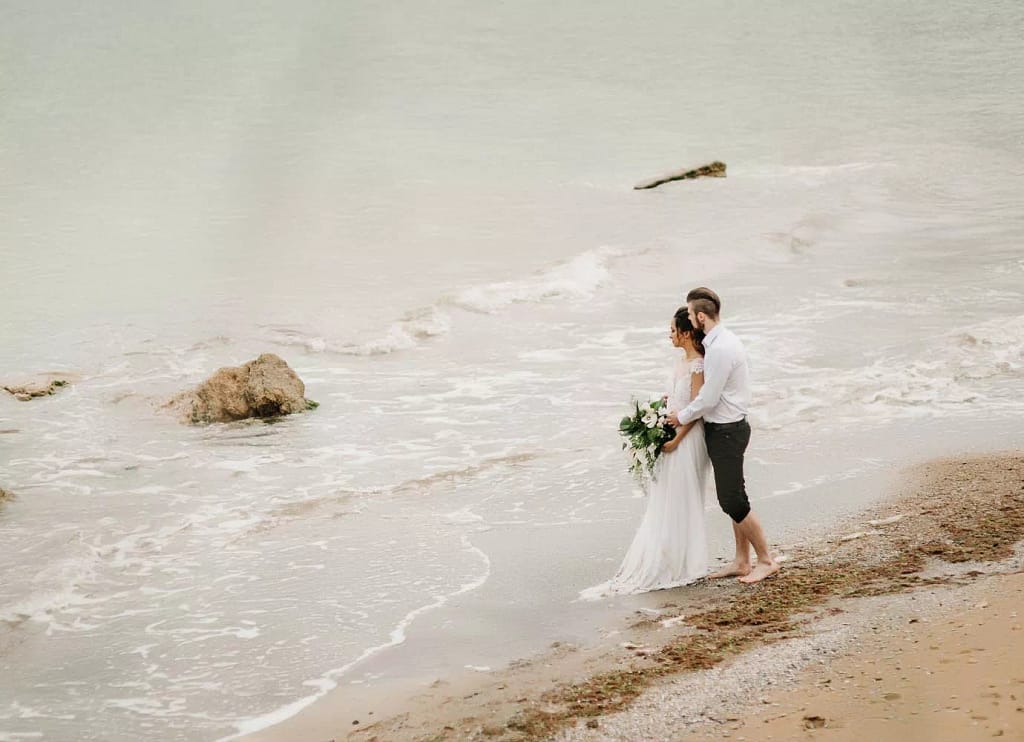 Photo of a foreign couple on a beach in Bali. Photo taken using a drone.