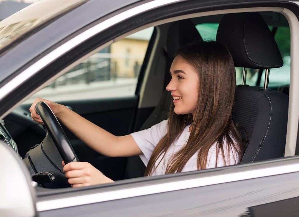 a European woman is driving a car in Bali