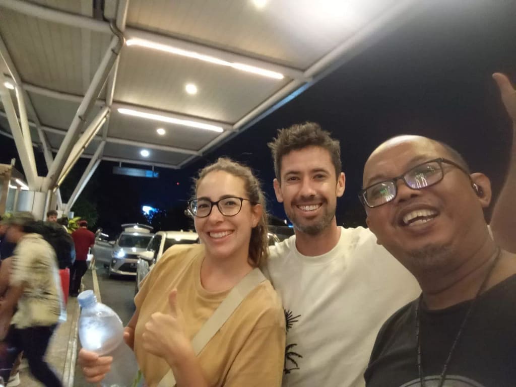 photo of a Hey Bali driver with two tourists at Bali airport