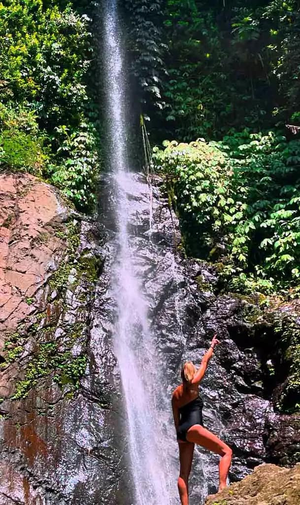 tourist woman pose with background hidden gem spot in karangasem