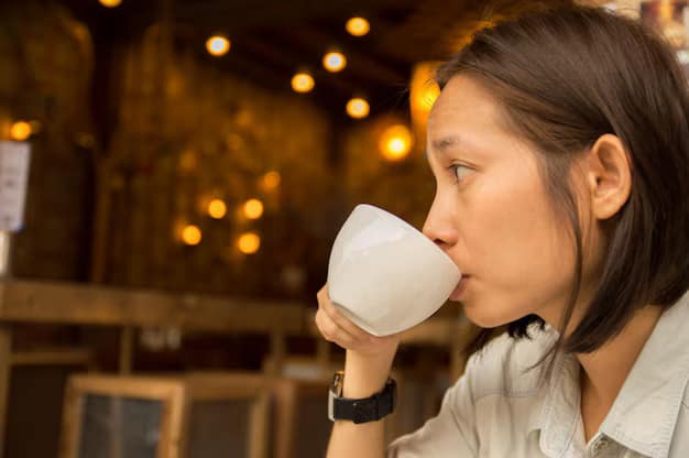 Woman sipping a hot beverage in a warmly lit coffee shop, featuring blurred bokeh lights in the background - Hidden Coffee Shops in Sanur