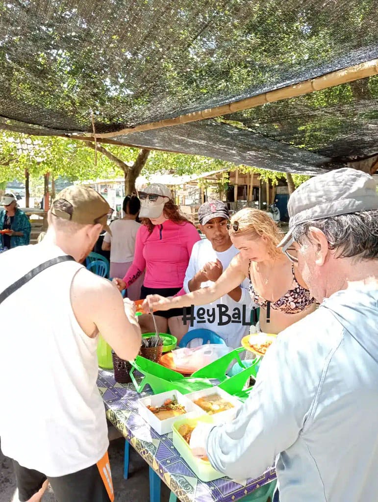 Hey Bali guests enjoying lunch at Tangsi Lombok Beach and seem to really enjoy the grilled fish menu provided.