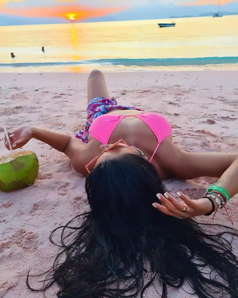 Beautifull Photo tourist woman with sunset background at pink beach lombok - best for posting at instagram