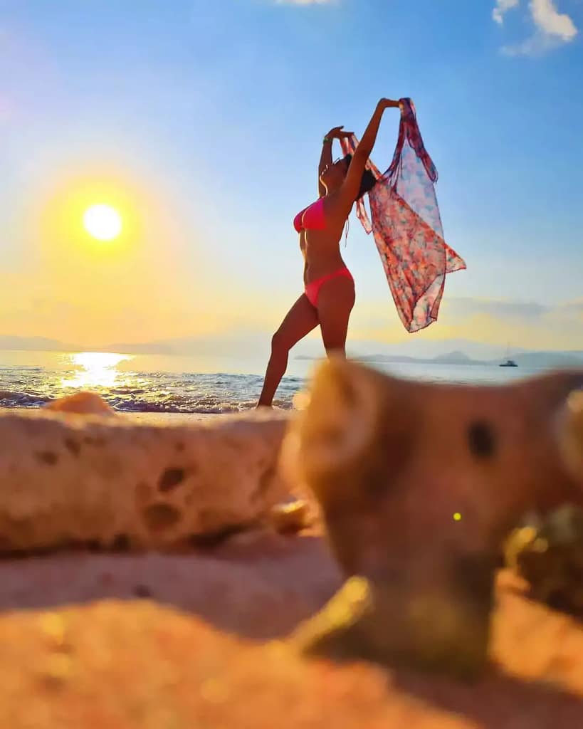 Beautifull Photo tourist woman with sunset background at pink beach lombok - best for posting at instagram