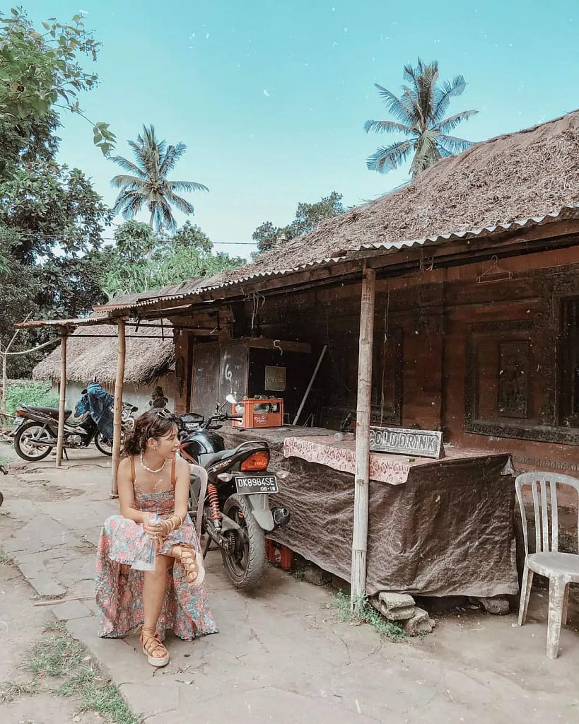 A photo of one of the Hey Bali team posing in a corner of Tenganan Pegringsingan village. 