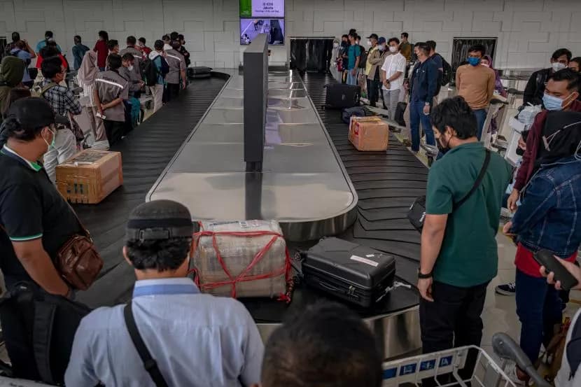 Airplane passengers are waiting for their luggage at Bali airport