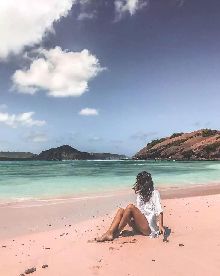 Tourist woman Pose at Pink Sand Beach Lombok