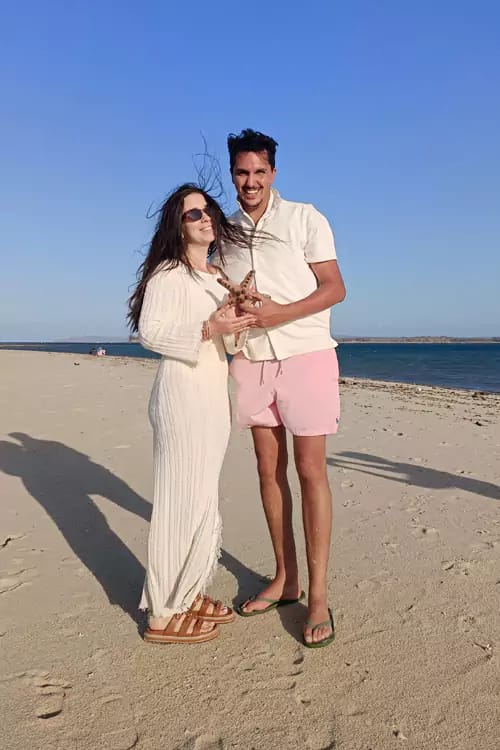 A couple of Hey Bali guest travelers look happy taking pictures on Lombok beach