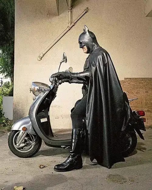 Batman riding a scooter in Bali - Dark Knight struggles with Denpasar traffic