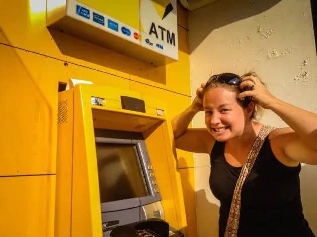 Bali Survival Guide - Photo of stressed female tourist in front of ATM machine in bali