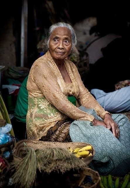 a Balinese grandmother is glancing