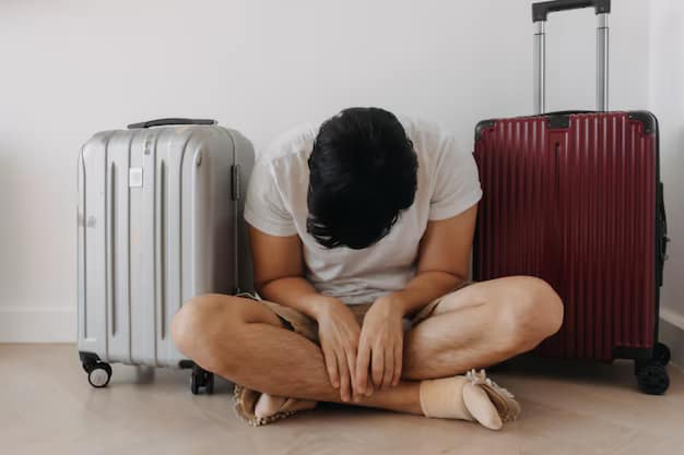 Sad and disappointed man sitting with his luggage. This is the ultimate feeling of anticlimax when one mistakes a symphony for a ringtone, leading to the mistaken belief that Bali is boring.