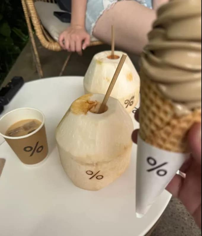 Fresh drinks at % Arabica: Two whole coconuts, iced coffee cup, and a coffee flavored soft serve ice cream in a waffle cone