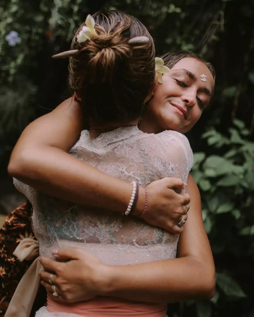 
A female tourist after completing the melukat ritual feels peaceful and calm - Bali spiritual tourism